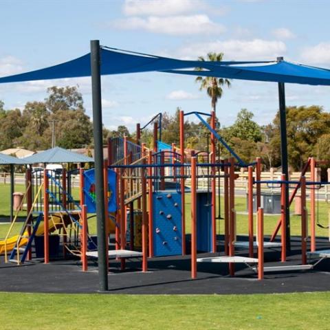 Playground equipment protected by the sun with shade sails