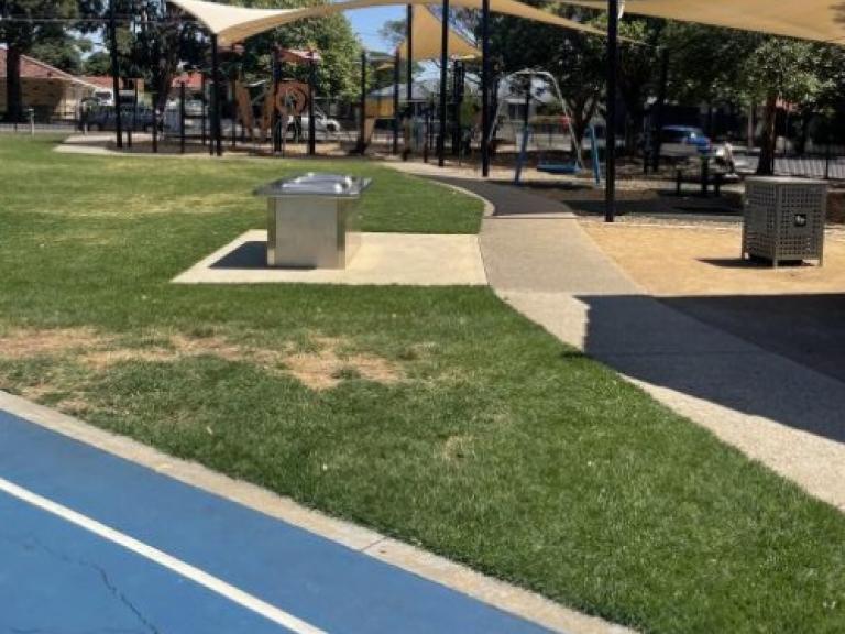 Shaded play area and BBQs