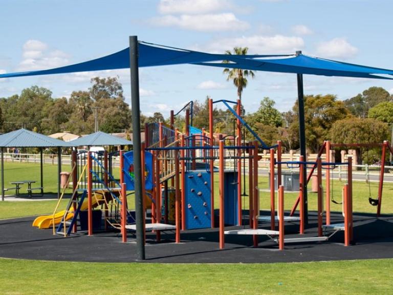 Playground equipment protected by the sun with shade sails